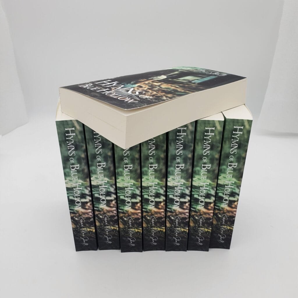 A stepped pyramid of hardcover books with dark green spines and vertical white text along the spines, stacked to form a blocky display.