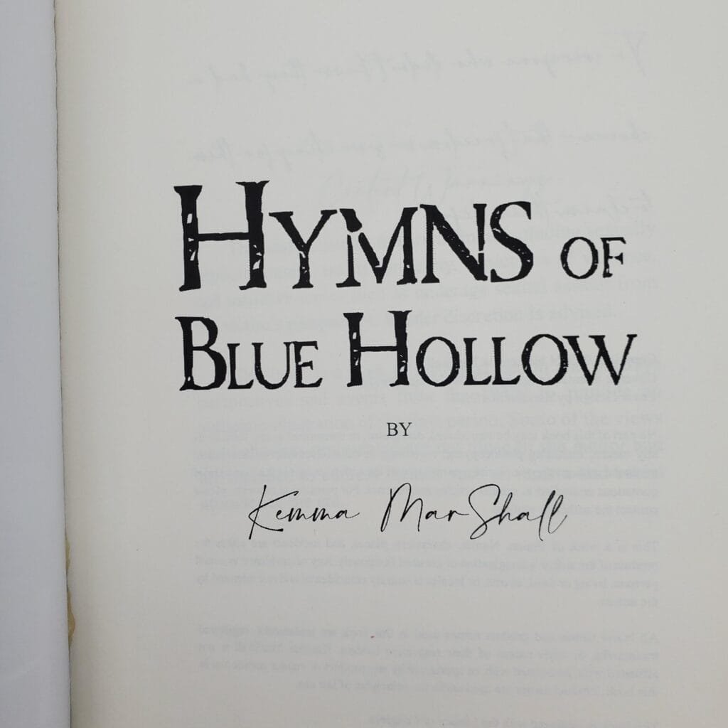 Page from a book showing a large serif title reading 'HYMN S OF' with the subtitle 'BLUE HOLLOW' and a small 'BY' line beneath, plus a handwritten signature near the bottom.